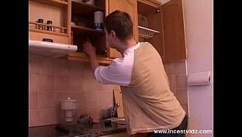Mature mom and young guy on the kitchen
