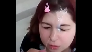 Redhead with a face influential of milk in a public bathroom