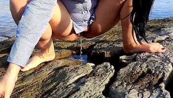 Wife pees outdoor on the beach